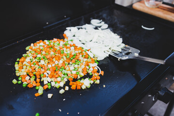 grilled diced vegetables and onion rings on the barbecue, healthy plant-based food