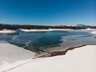 Frozen winter season at Boca reservoir. Icy lake and snowy shores