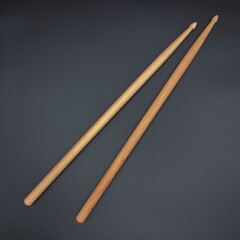 Percussion drumsticks on a black background.