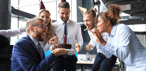 Business team celebrating a birthday of collegue in the modern office