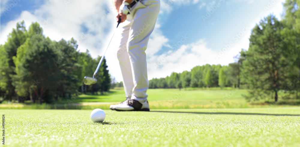 Wall mural golf approach shot with iron from fairway at sunny day.