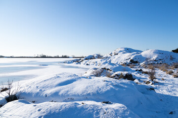 Fototapeta na wymiar Winter landscape on sunny day, with coastline and frozen sea. Gothenburg, Sweden 020621
