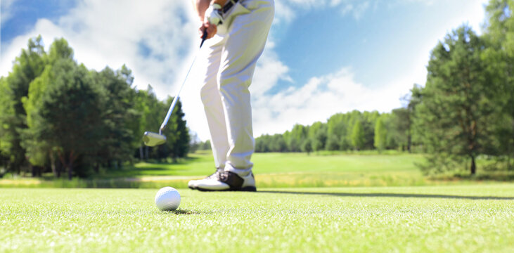 Golf approach shot with iron from fairway at sunny day.