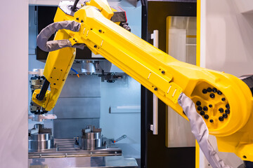 Robotics in production. Yellow arm manipulator in production. Manufacturing arm manipulator close up. Manufacturing using robotics. Modern equipment at the factory. Modern heavy industry.
