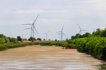 View of wind turbines and North Crimean Canal in Kherson region, Ukraine. Wind power station. Renewable energy