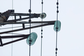 Supports of power lines. Power lines and posts. Detailed close-up.