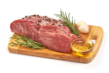 Raw veal meat with spices and oil, prepared for cooking, isolated on white background