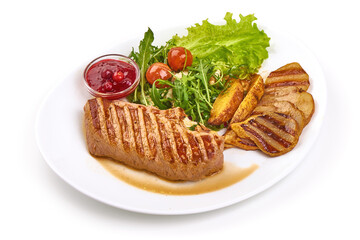 Grilled beef steak with potato wedges, grilled pears and arugula salad with feta cheese, isolated on white background