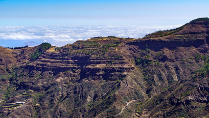 View of the high mountains of the Canary Island of Gran Canaria with the clouds below on the horizon.
