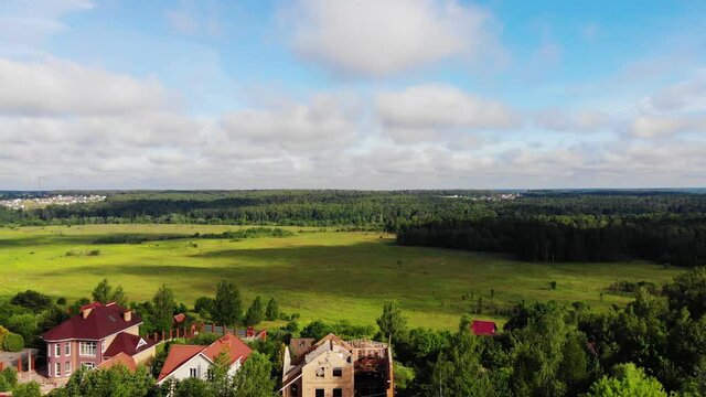Abandoned cottage ready for demolition near lush green field