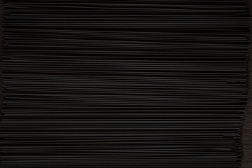 Fototapeta premium Black spaghetti background. Spaghetti squid ink 