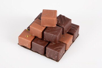 some piece chocolate pralines in pyramid view in white background