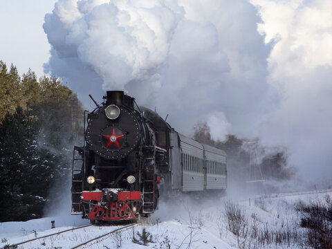 Vintage black steam locomotive in Russia in the winter.