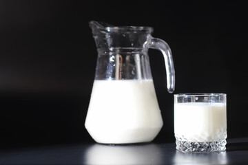 Milk drink in a glass. Farm milk and cookies. Delicious snack with cow's milk and fresh pastries.