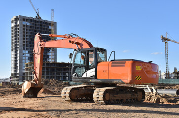 Excavator on earthworks at construction site. Backhoe on foundation work and road construction....