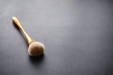 Powder and makeup brush. Brown powder on the background. Makeup products. Style concept.