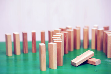 Stick wood block standing on stacked square wood blocks, abstract background in concept of winning, success, challenge, step to top position.