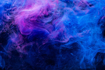 Fototapeta na wymiar Neon smoke. Colorful background. Paint in water mix design. Cosmic explosion. Glowing vivid blue pink fog cloud flow on dark abstract night sky.