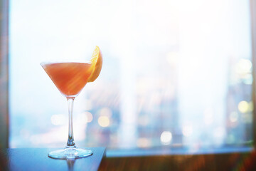 Cocktail glasses on the windowsill by the glass