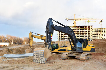 Excavator on earthworks at construction site. Backhoe on foundation work and road construction....