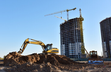 Excavator on earthworks at construction site. Backhoe on foundation work and road construction....