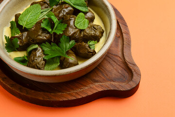 Piping hot baked cabbage rolls with sauce ready to serve. Traditional Georgian cuisine concept.