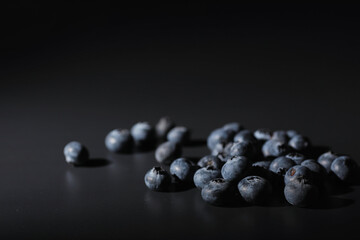 Water drops on ripe sweet blueberry. Fresh blueberries background with copy space for your text. Vegan and vegetarian concept. Macro texture of blueberry berries.