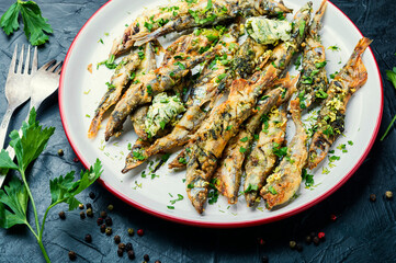 Fried capelin fish on plate