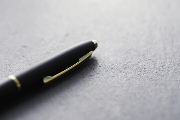 Office supplies on the table. A fountain pen. Business pen in the office on a stone surface.