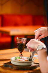 Dinner at Georgian restaurant. Eating out concept, eating BBQ fiery sausages with vegetables.