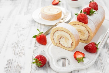 Tasty roll cake stuffed with cream cheese ,decorated with fresh strawberry