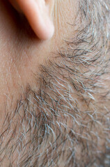 Close-up of an unshaven male face. Selective close-up macro photography with a blurry background
