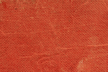 The texture of the old book cover is orange. Grunge background, worn vintage surface