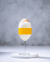 Italian dessert panna cotta with tangerine jelly layer in a glass