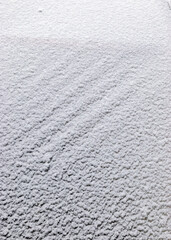 Abstract snow texture fragments on film greenhouse, white snow, winter day