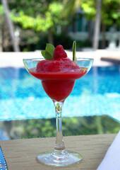cold strawberry drink in Thailand on blue pool background