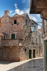 Fototapeta na wymiar Hvar island, Croatia, popular touristic destination. Colorful traditional European houses on a sunny day