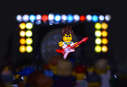 Lörrach, BW  Germany - February, 06 2021: Lego minifigure popstar with red guitar. Editorial illustrative image of entertainment concert. Studio shot.