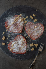 heart shaped red velvet pancakes on a table