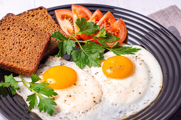 fried eggs with bacon and vegetables