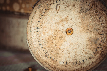 Vintage grunge background of an old clock. Abstract texture covered with dust, dirt, scratches. Macro photography in light tinted