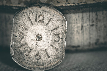 Vintage grunge background of an old clock. Abstract texture covered with dust, dirt, scratches. Macro photography in light tinted