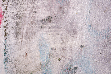 The texture of brush strokes of white paint on metal