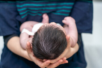 Head of a baby being held by its mother_07