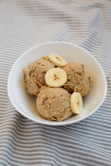 Homemade Peanut Butter Banana Ice Cream in a Bowl, side view.