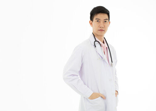 Portrait Of Asian Male Doctor In White Gown Coat On White Background With Copy Space.