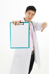 Asian male doctor holding and thumbs down dislike for blank medical chart with serious face