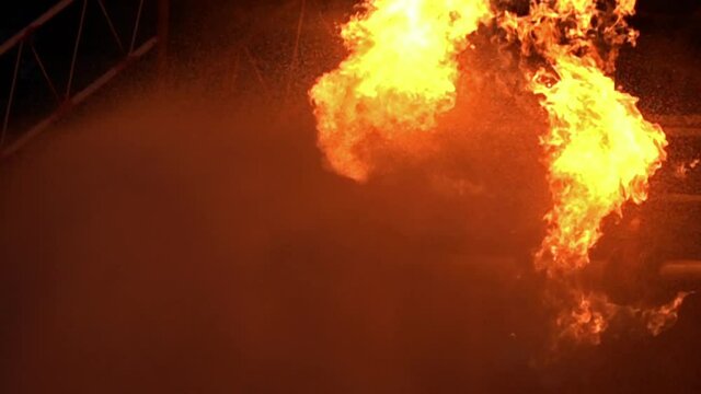 FHD Slow motion Water spraying from fireman to fight with Explode of oil pipeline leak and explosion on oil rig and natural gas station. Insurance and safety diaster concept.