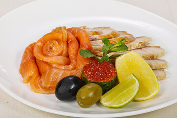 Sliced fish snack with salmon, caviar and strugeon