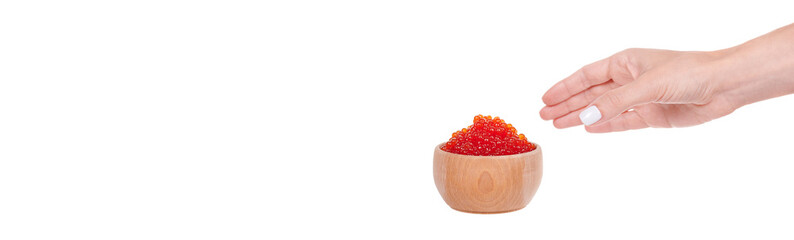 Hand with luxury red caviar in wooden jar, expensive healthy seafood, isolated on white background.